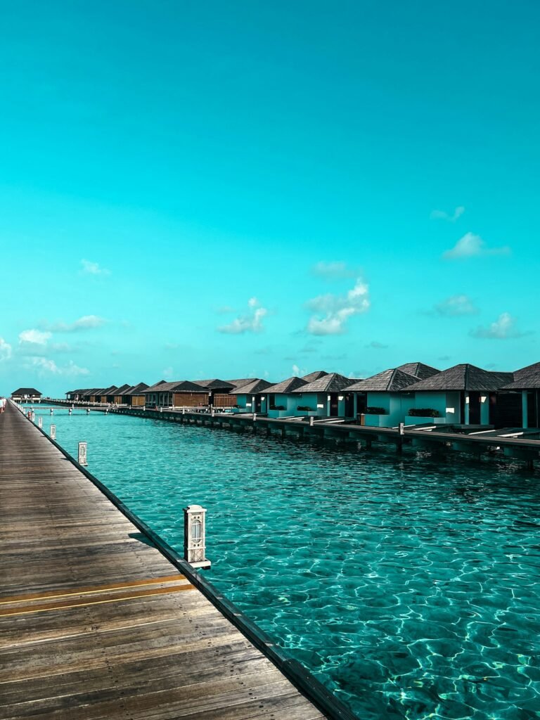 Overwater bungalow villas lining turquoise ocean, Maldives