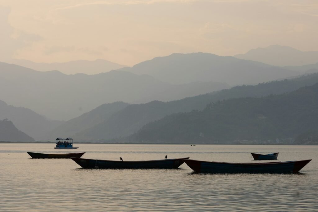 Boats on Phewa Lake near mountains, Pokhara, Nepal