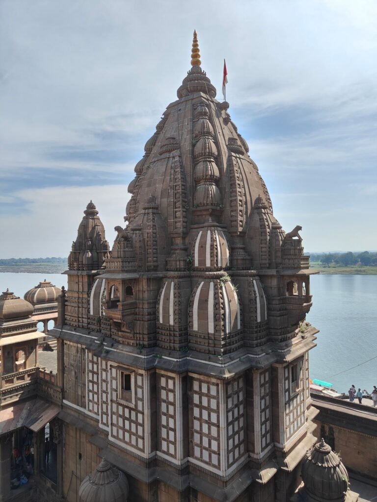 Drone/bird's-eye view of Ahilya Devi Maheshwar Fort tower overlooking Narmada River