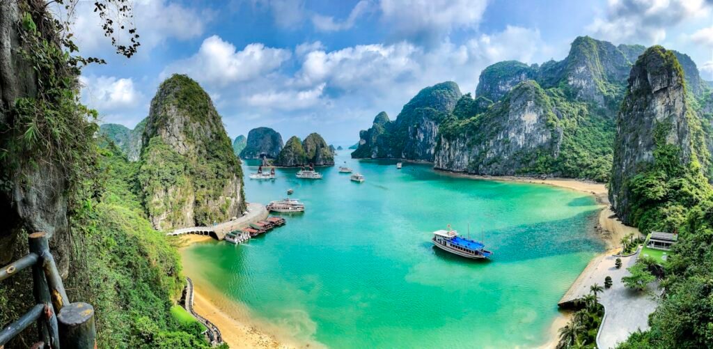 Boats on turquoise water amid limestone karsts, Halong Bay, Vietnam