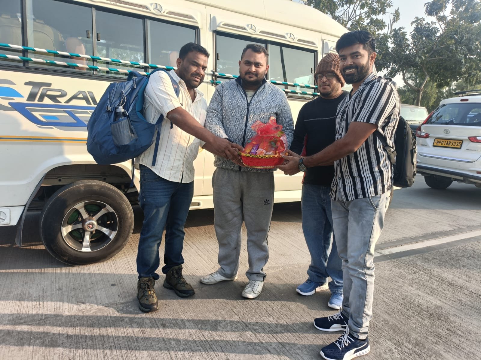 Siona Tours group being welcomed with a gift basket beside a Tempo Traveller