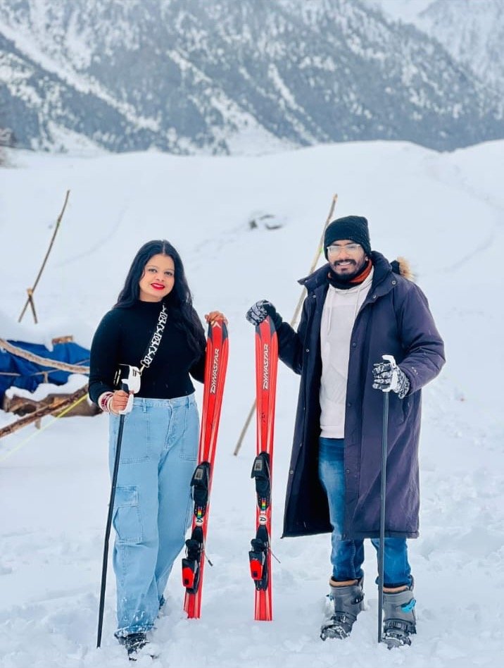 Siona Tours travellers posing with skis on a snowy mountain slope